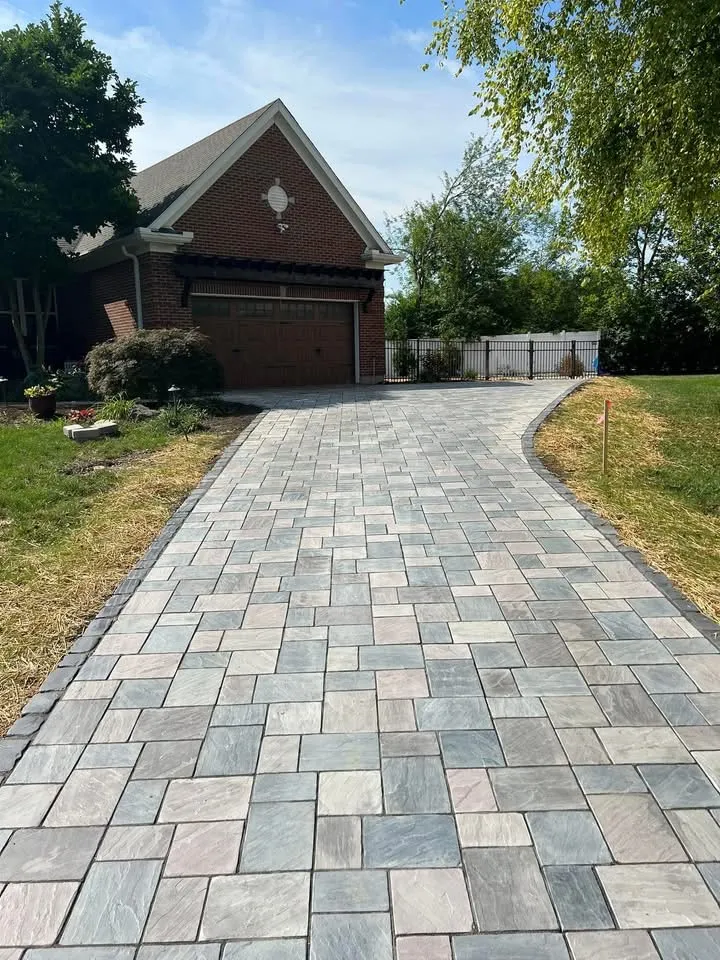 Heated Unilock paver driveway with contrasting border leading to the street
