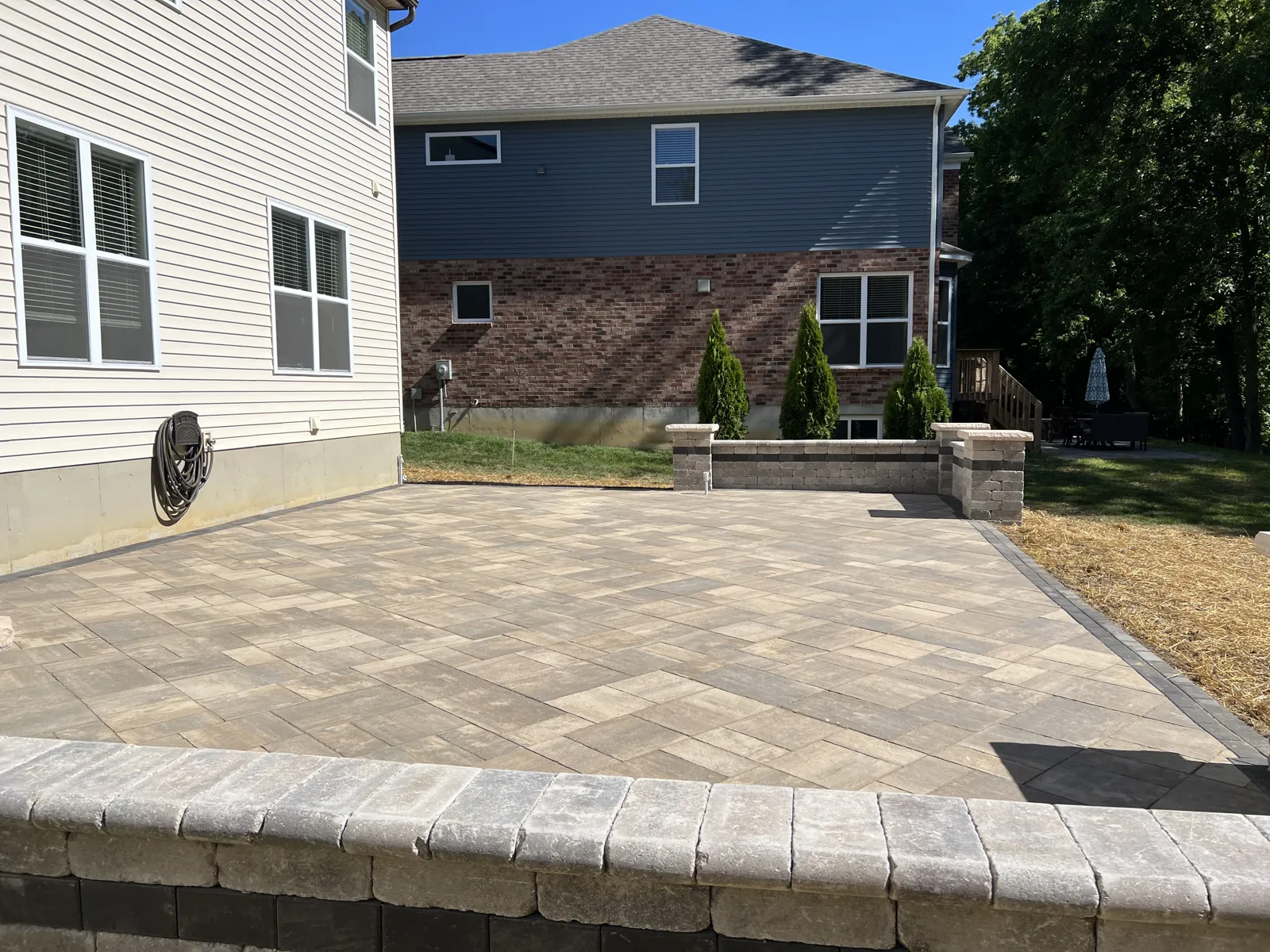 Paver patio with a seat wall and columns
