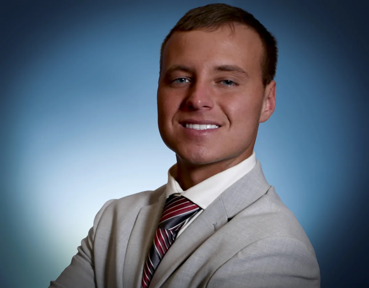 Marketing and Account Manager Logan, TJ's oldest son, in a professional headshot