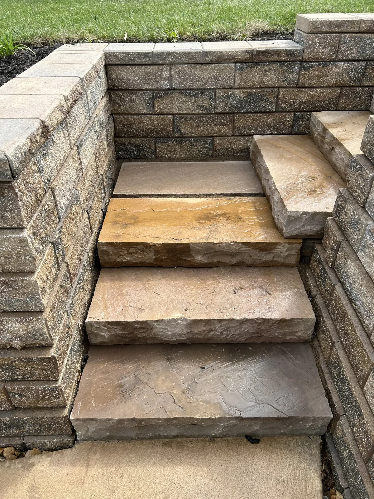 Natural stone slab steps between block walls