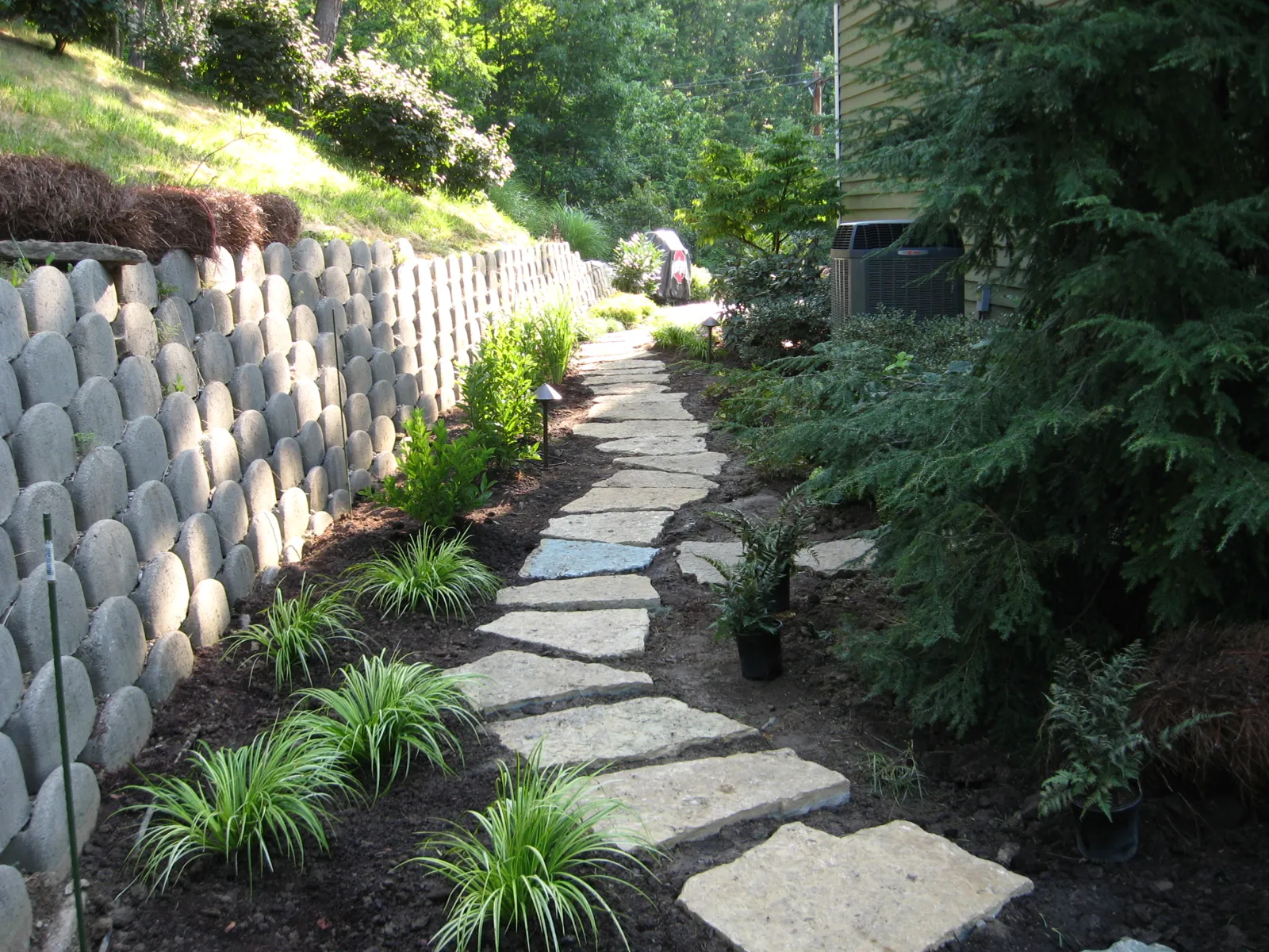 Flagstone path running beside a segmental block retaining wall