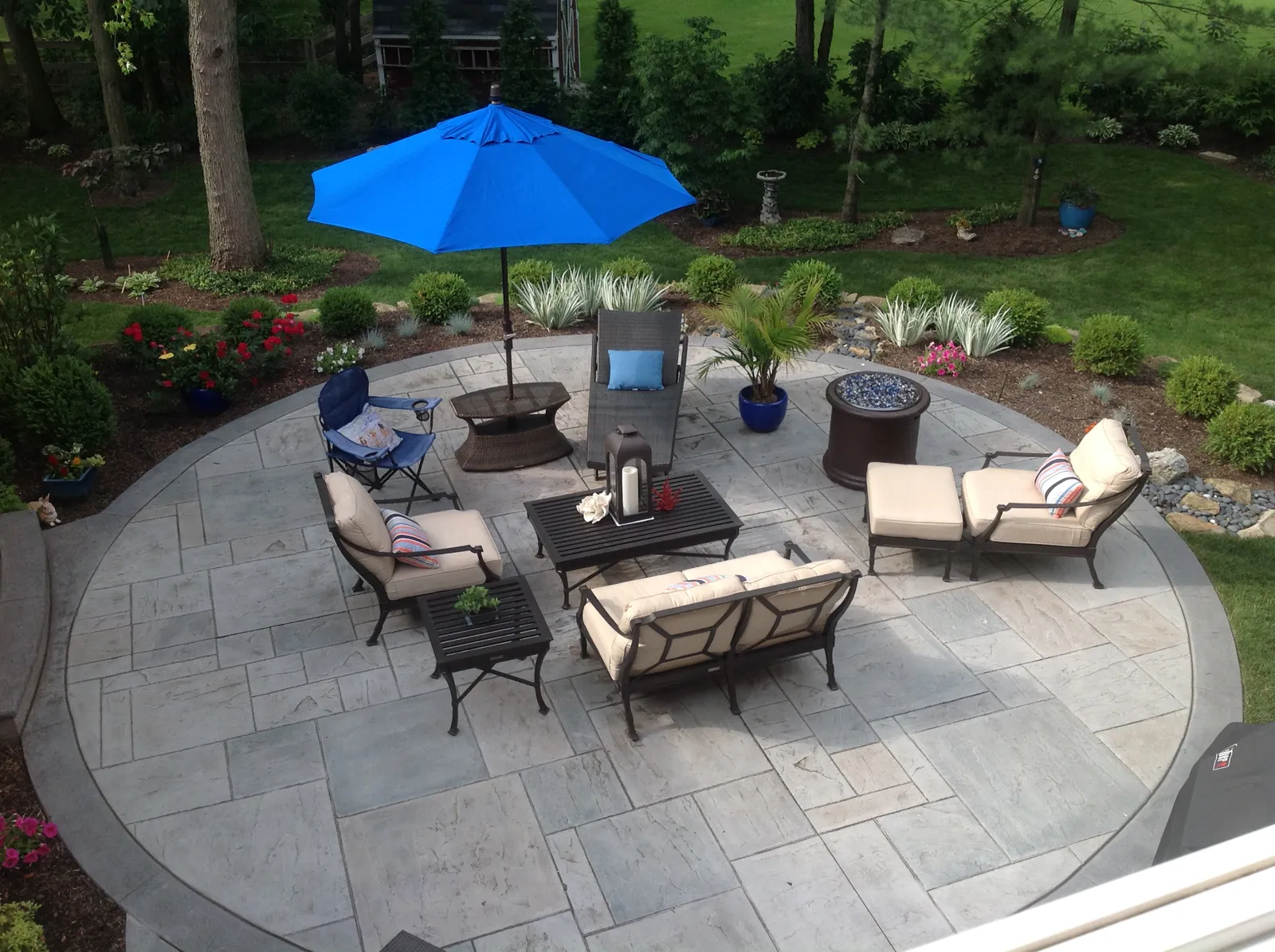 Circular stamped concrete patio set up as an outdoor living room