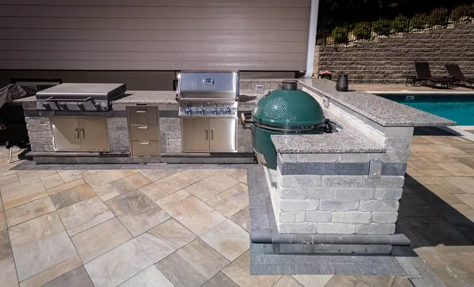 Finished paver terrace connecting a pavilion and swimming pool