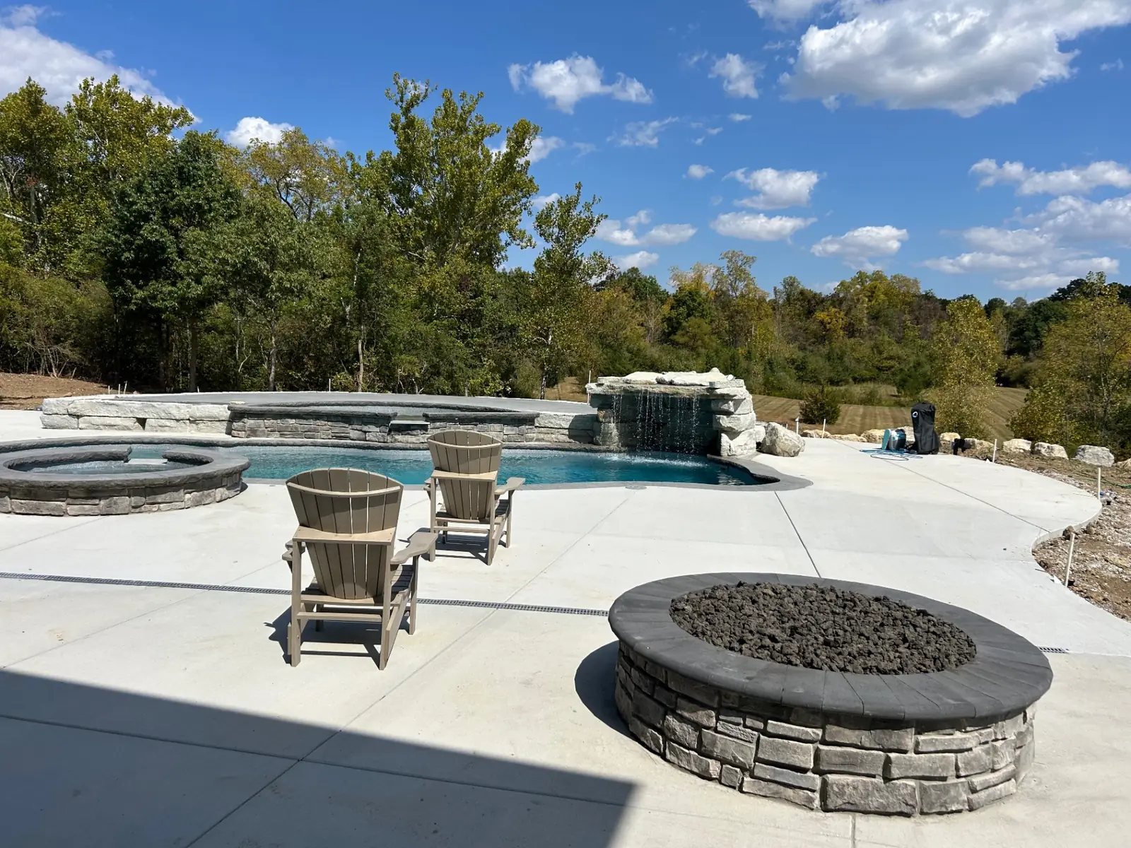Curved pool terrace with integrated landscape and fire feature